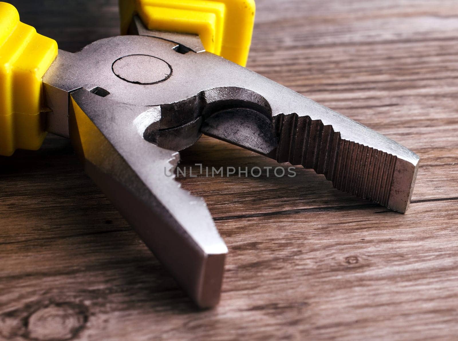 Close up of a multitool pliers on wooden background