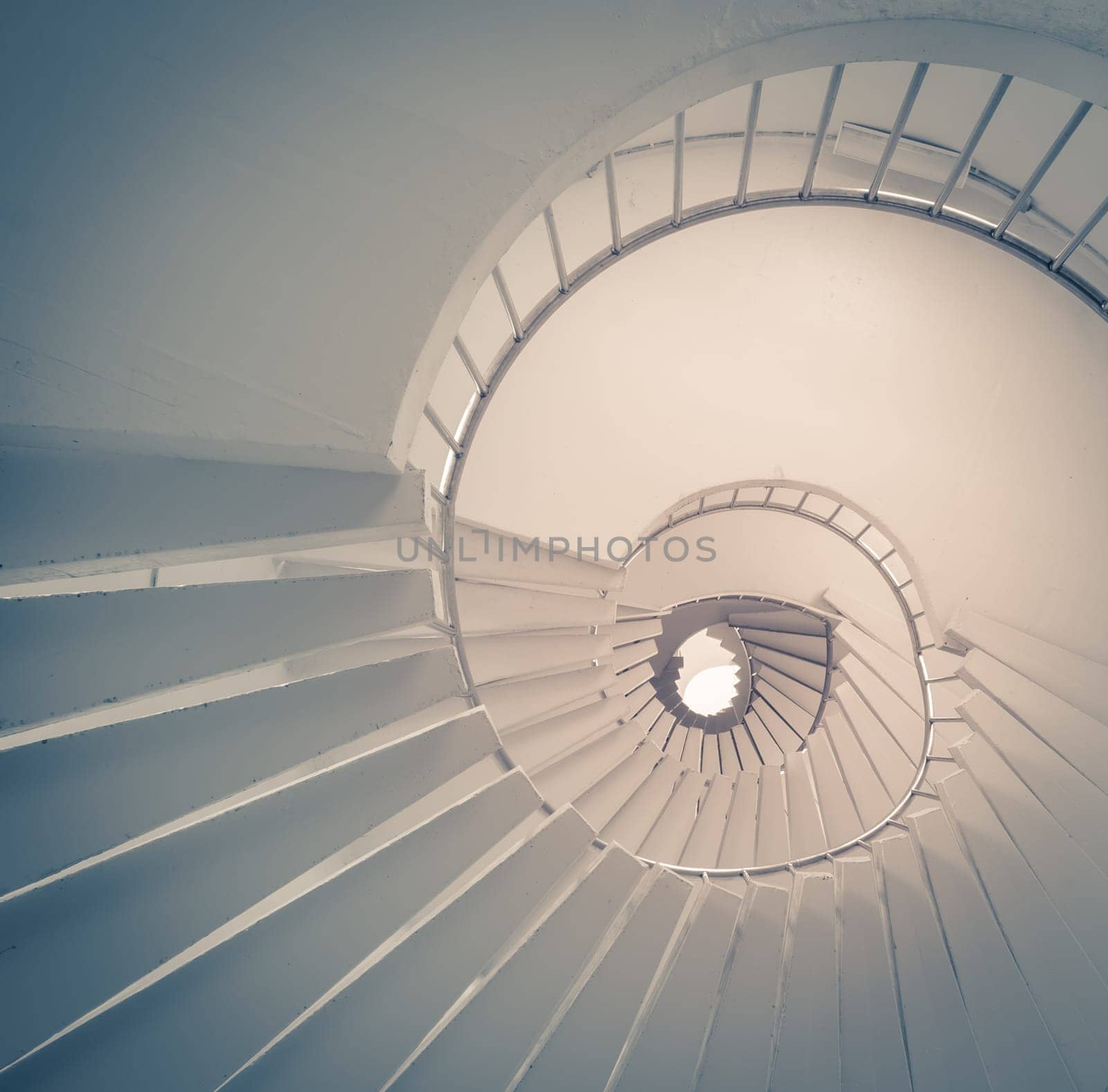 View of spiral staircase from the ground looking up. Vintage effect.