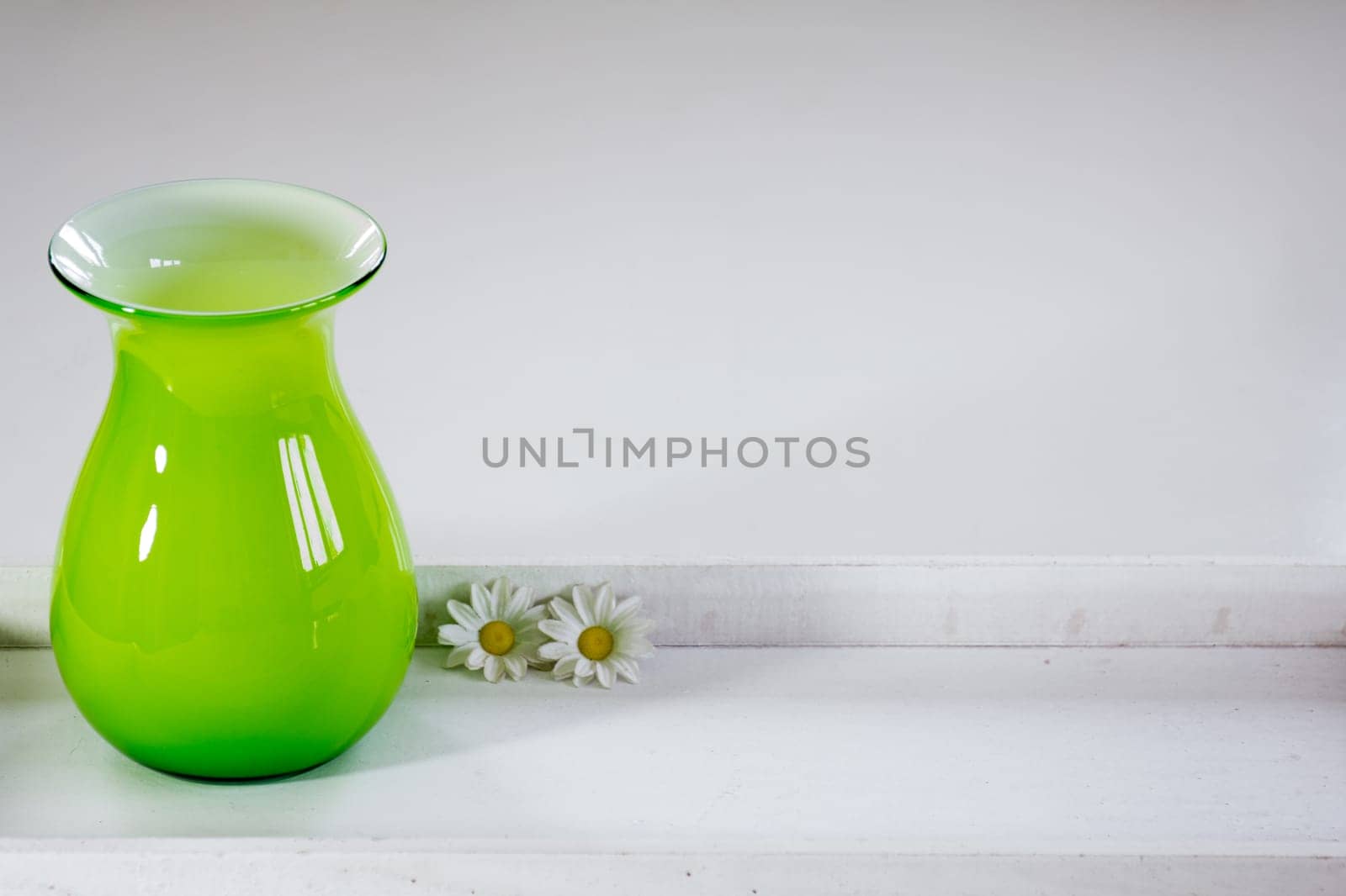 Green vase on a white tray