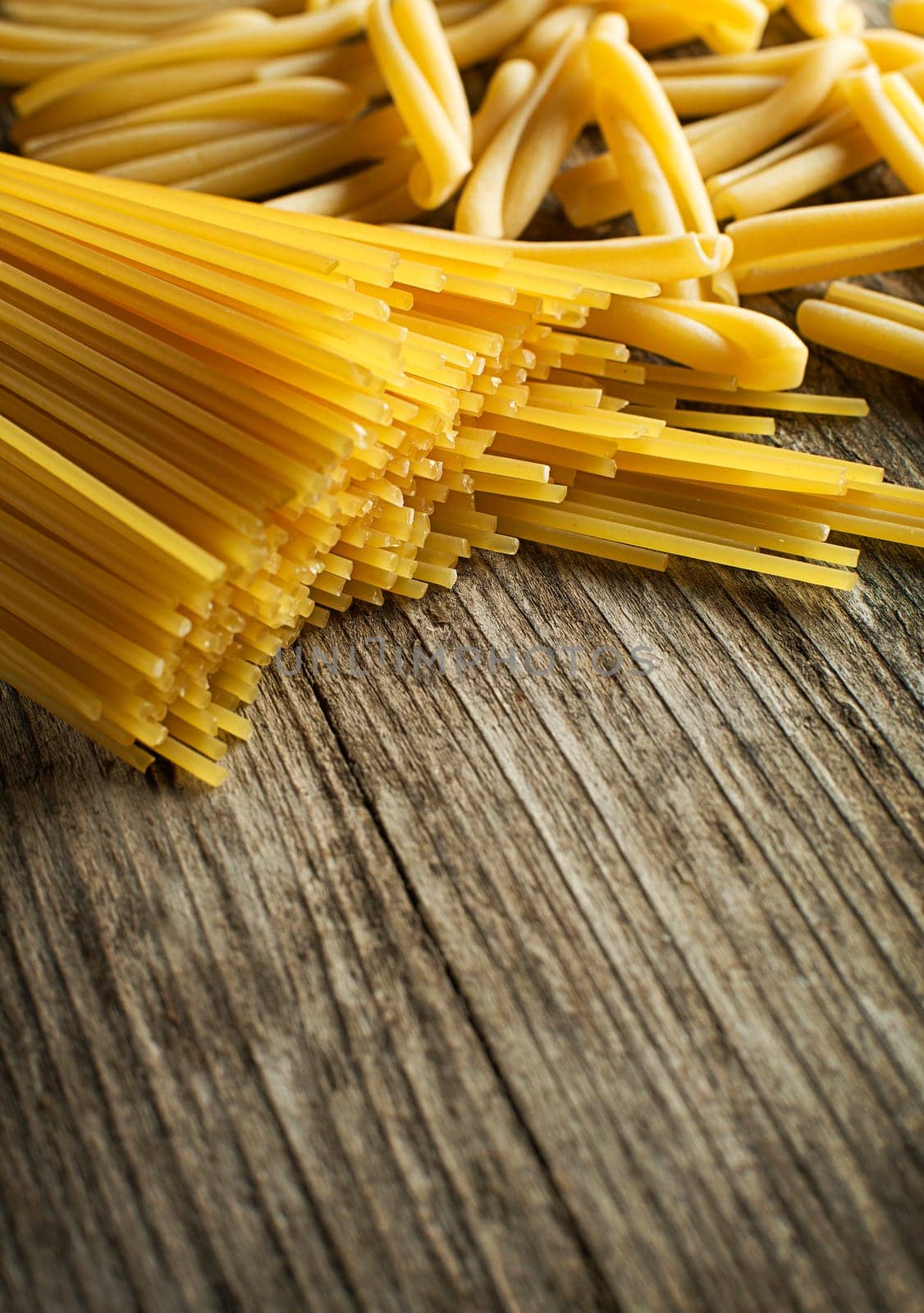 Pasta collection on rustic wooden background close up