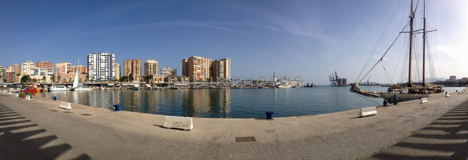 Harbor coastline panorama with sailing ship in the city of Malaga in Spain