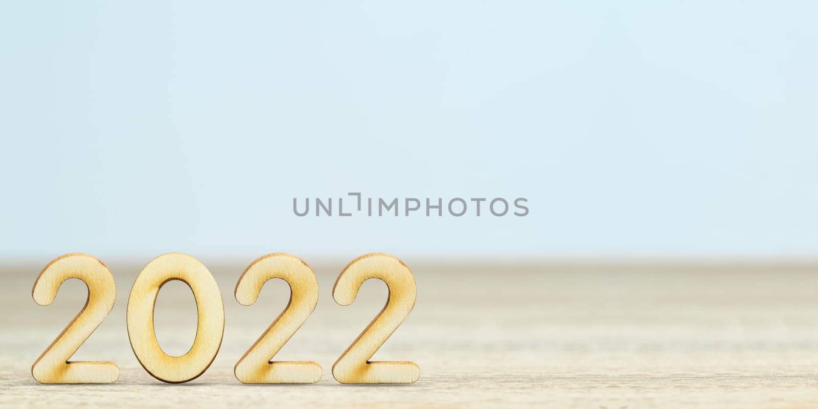 Wooden numeric new year 2022 on table with copy space