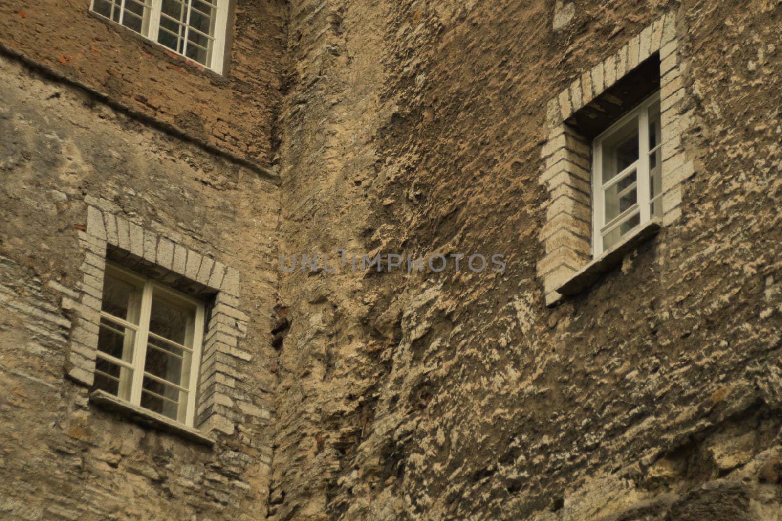 Old brown brick wall with windows background
