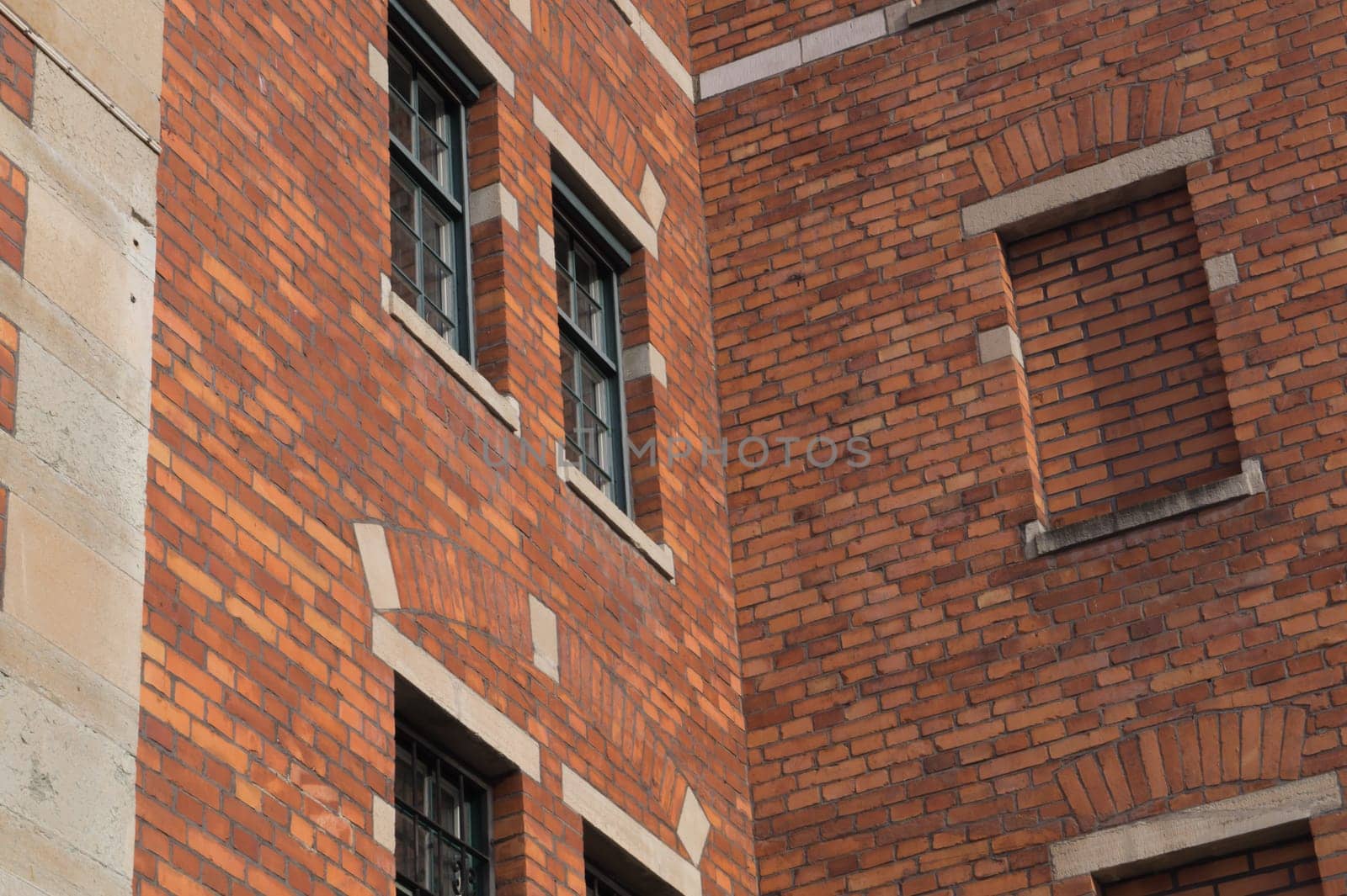 Old brown brick wall with windows background