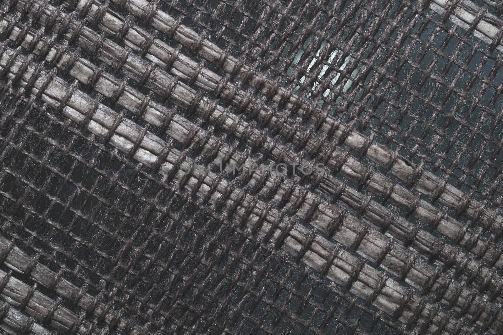 Braided fibers close up. woven texture. wicker background. knitted surface. weaving pattern. weaving from threads