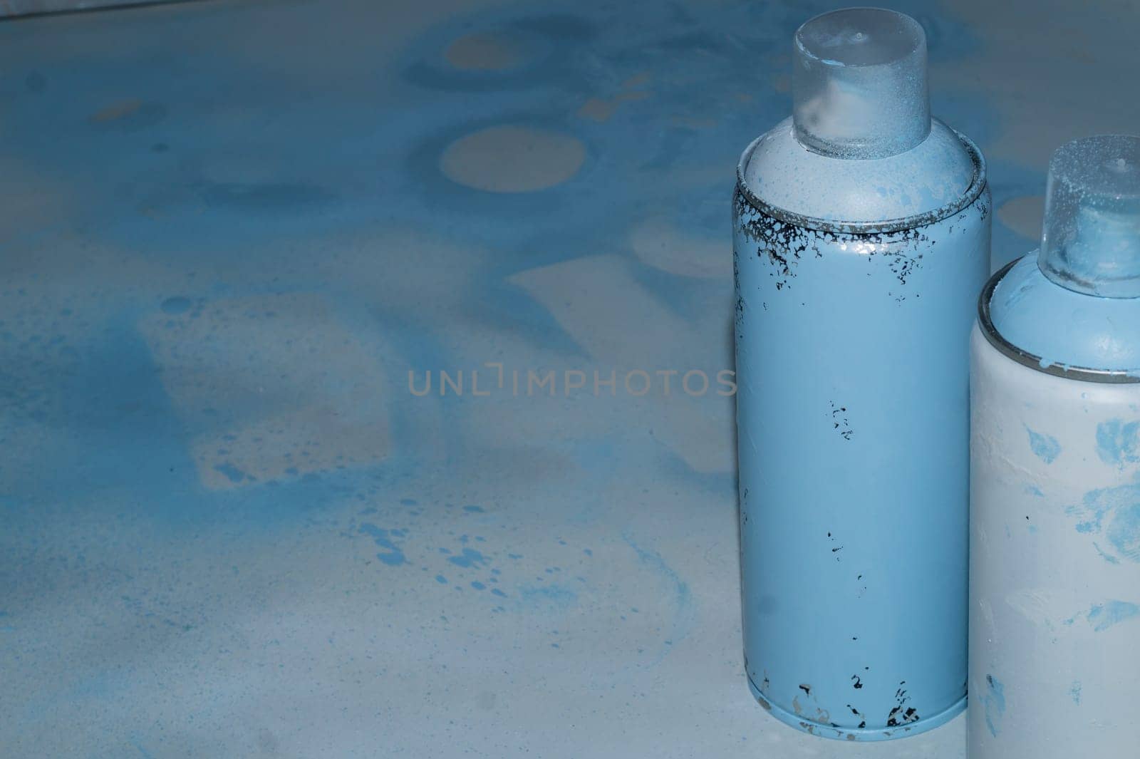Spray paint can on dirty background