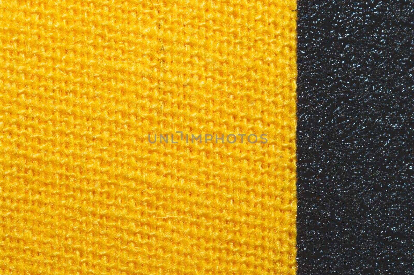 Black and yellow fabric texture. knitted textile close up. woven background macro