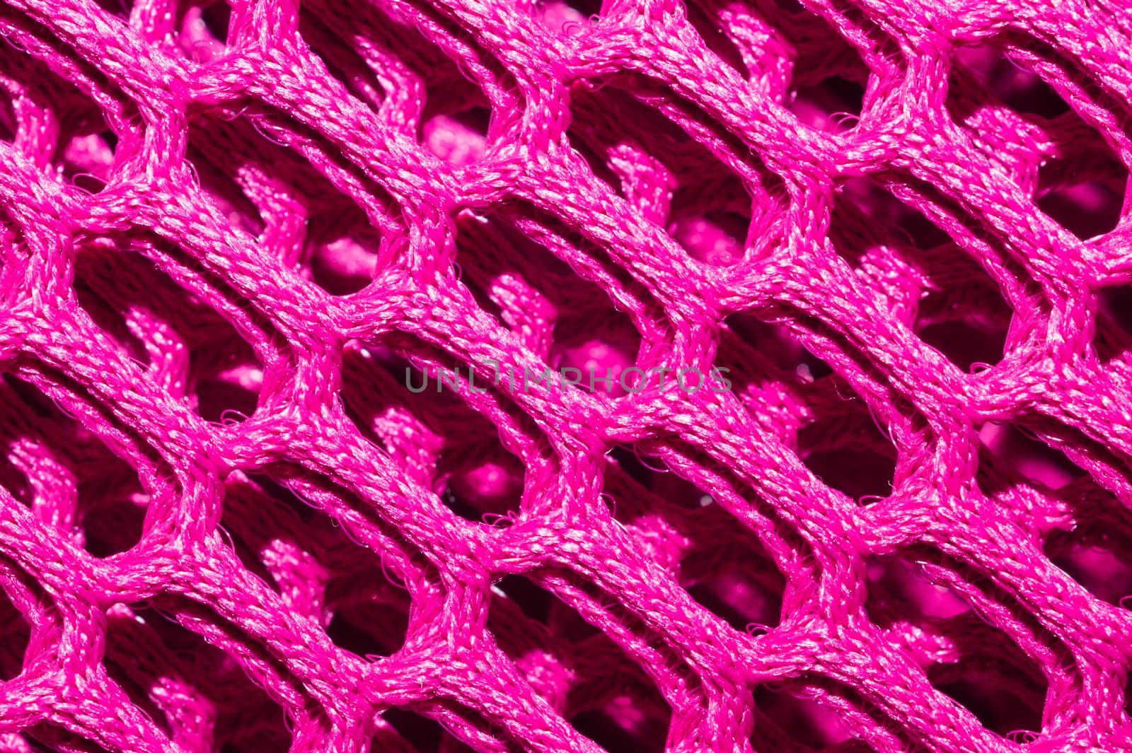 Pink fabric texture macro. abstract knitted pattern. woven material. textile background