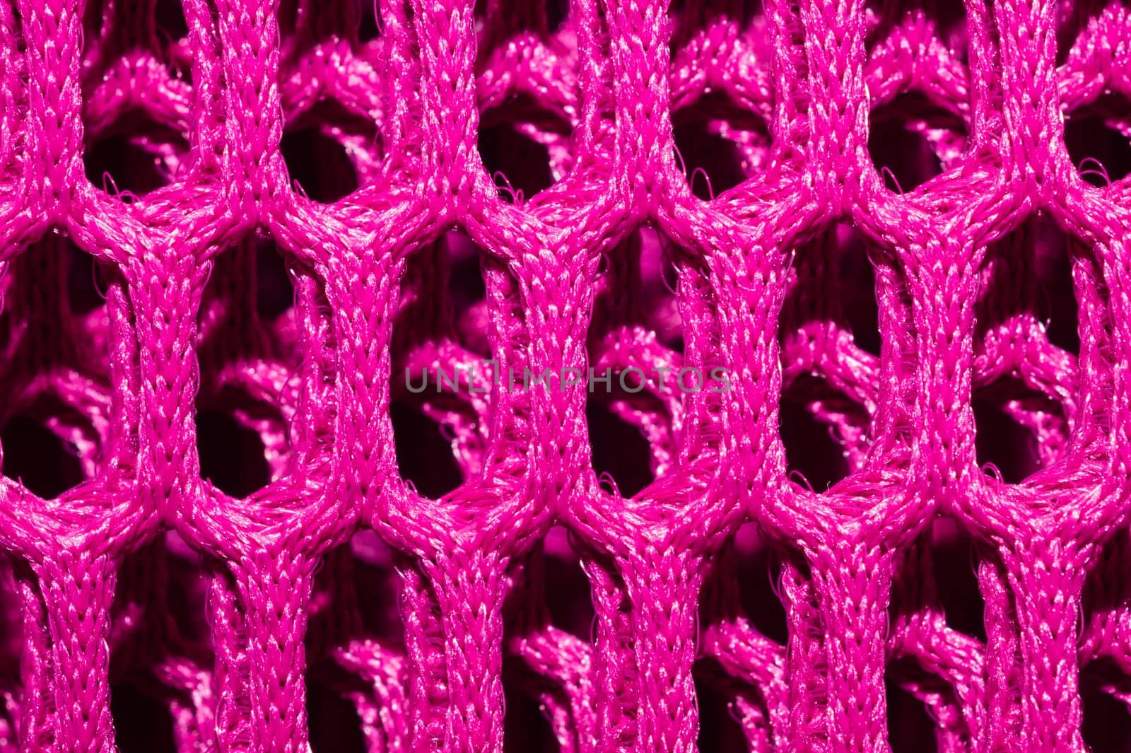 Pink fabric texture macro. abstract knitted pattern. woven material. textile background