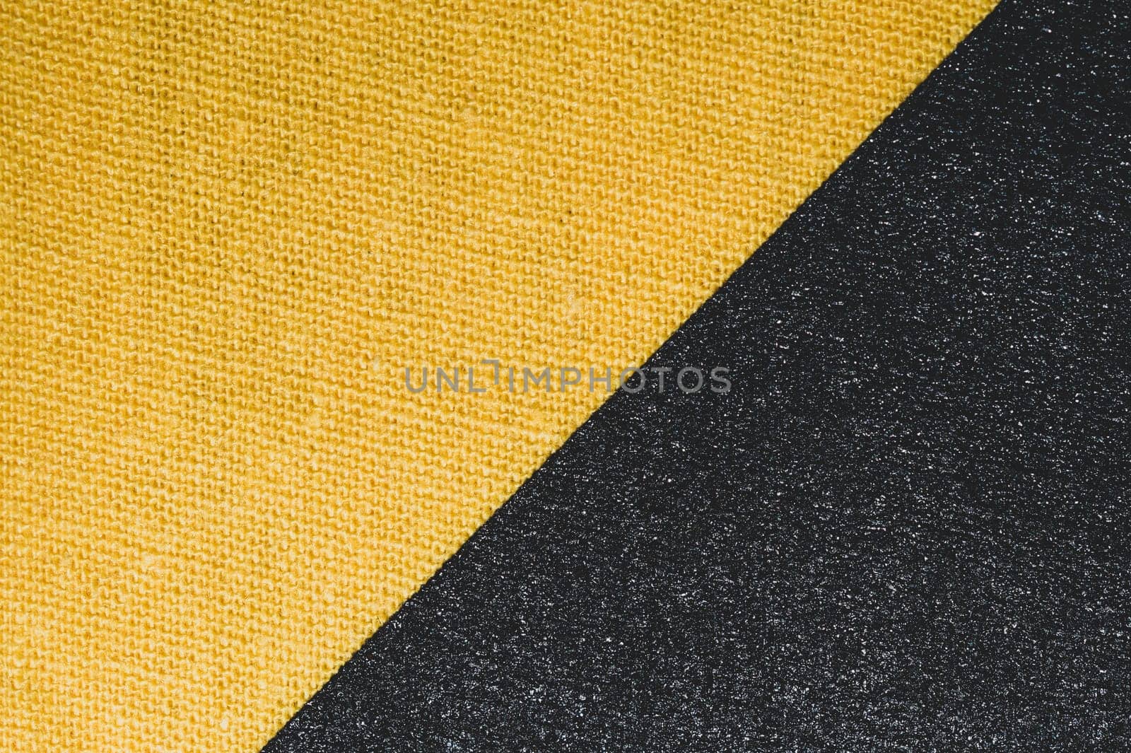 Black and yellow fabric texture. knitted textile close up. woven background macro