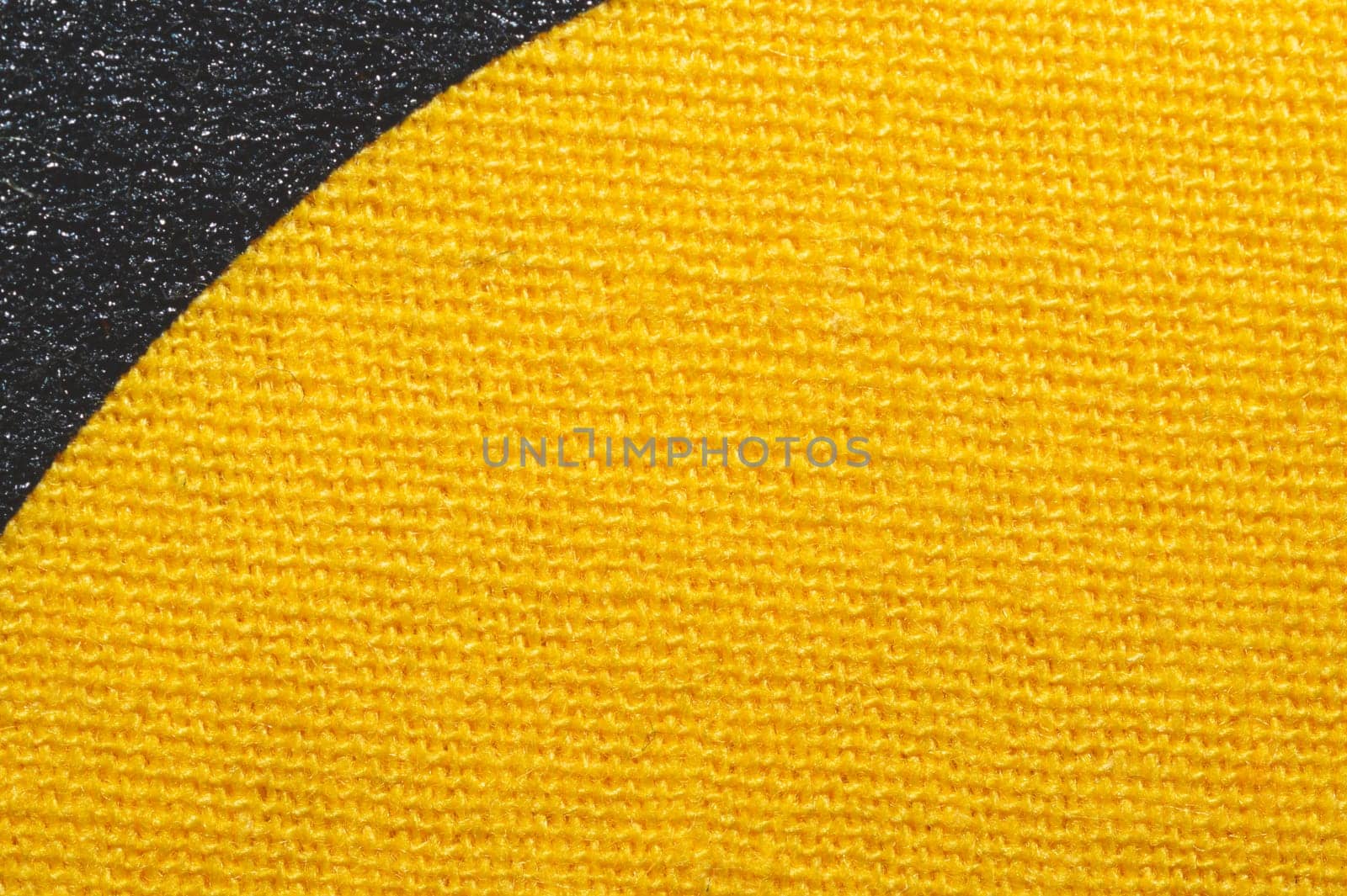 Black and yellow fabric texture. knitted textile close up. woven background macro