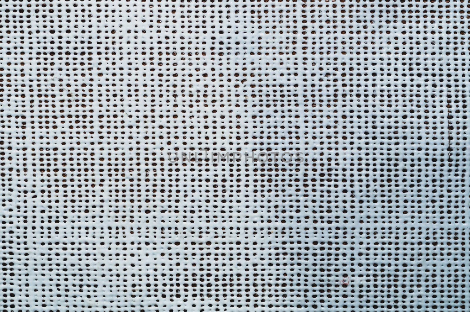 Rubber surface with uneven holes. white plastic texture with dots. abstract background