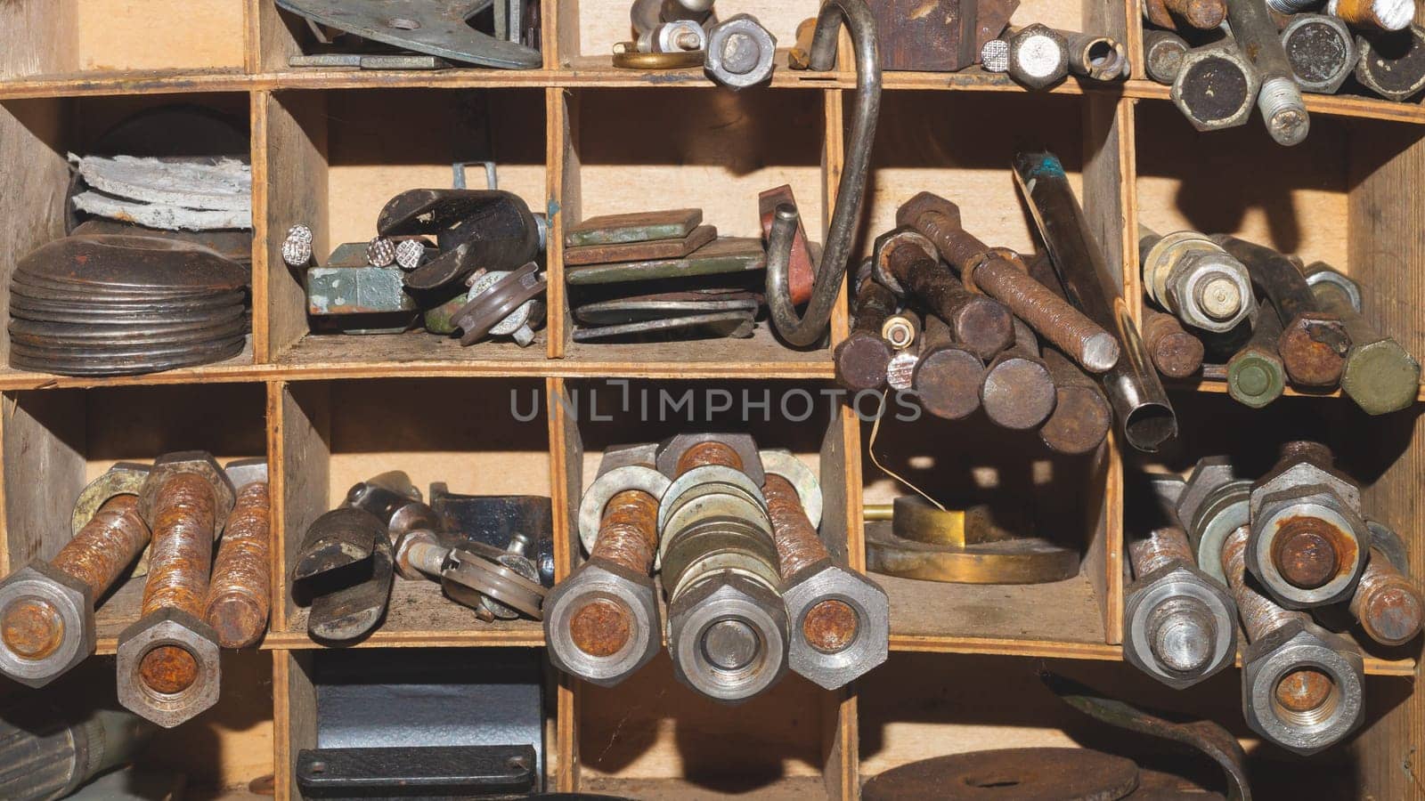 Metal bolts and nuts in the work shelf. various fasteners. rusty details in workshop