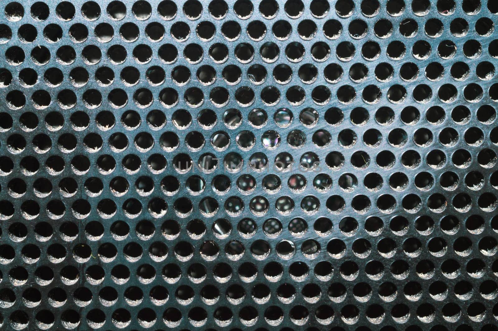 Grid pattern surface. dusty speaker mesh texture close up. perforated plastic. abstract background