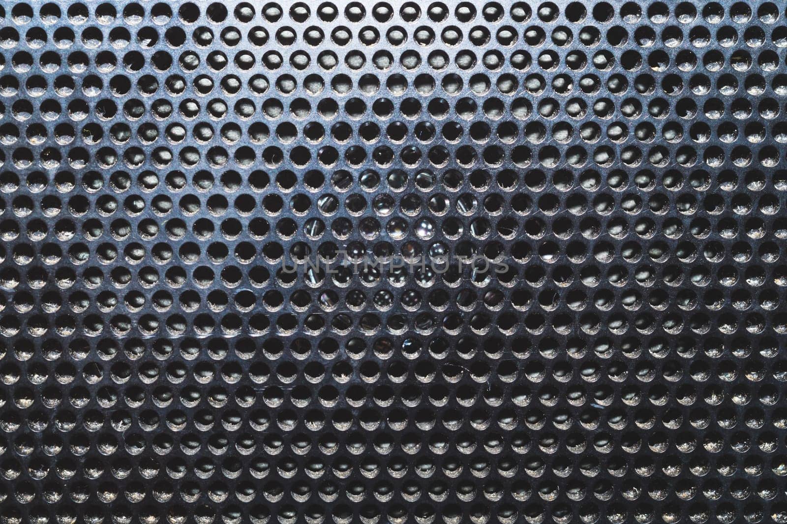 Grid pattern surface. dusty speaker mesh texture close up. perforated plastic. abstract background