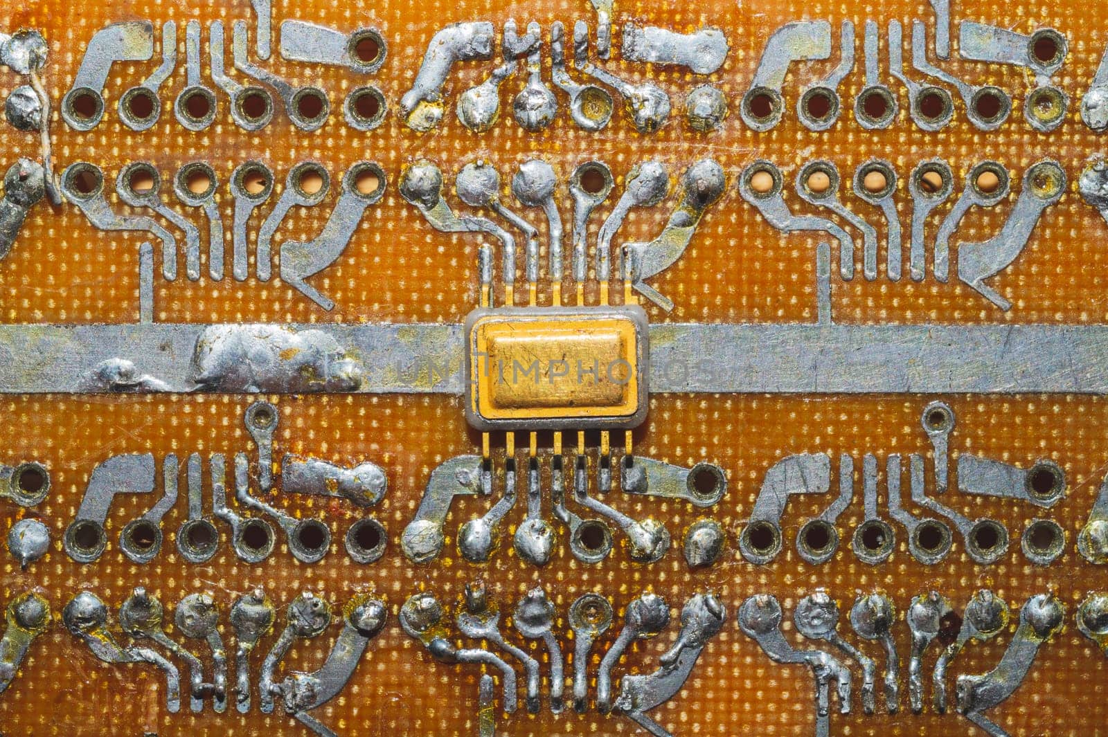 Handmade circuit board with microchip. integrated scheme. industrial background. tracks on textolite