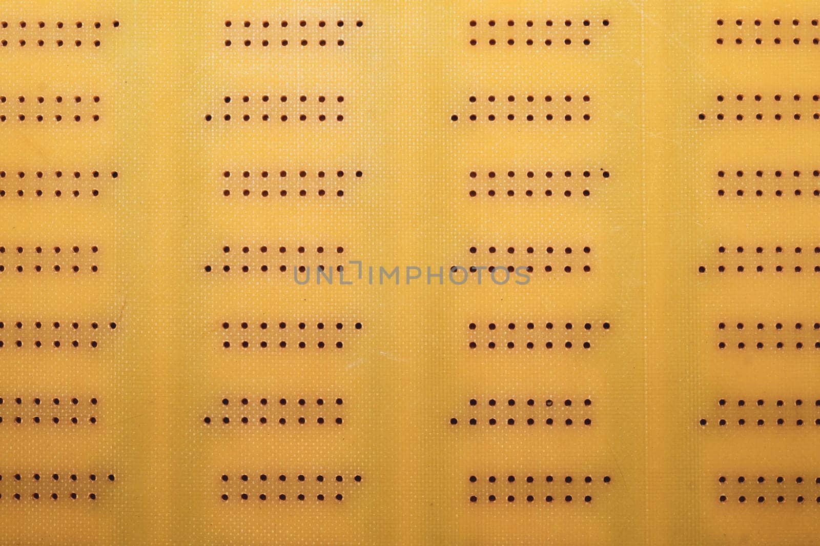 Dotted textolite surface. template for soldering the circuit. perforated background