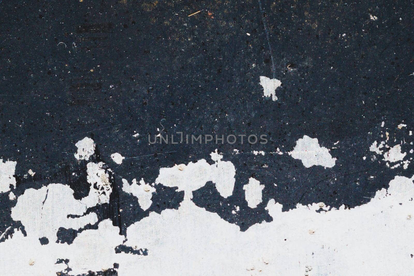 Black steel plate with white paint spots. metal surface with paint splashes. grunge texture. iron background