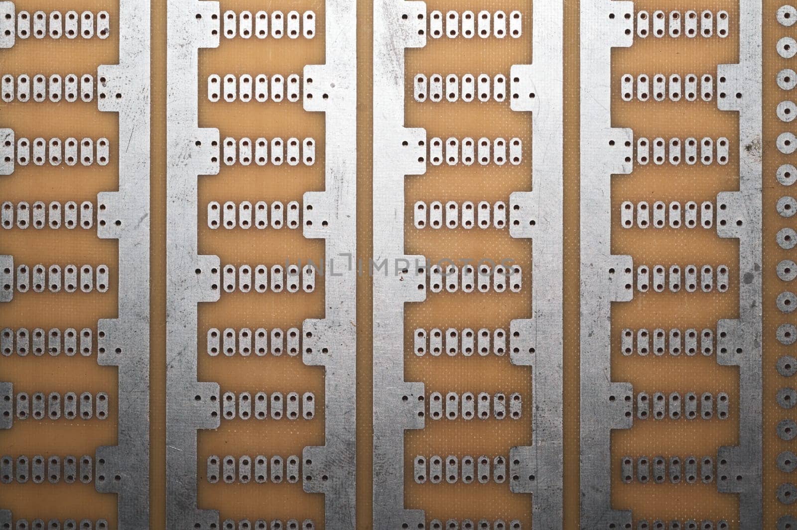 Printed circuit board without elements. textolite surface. template for soldering the circuit. perforated background