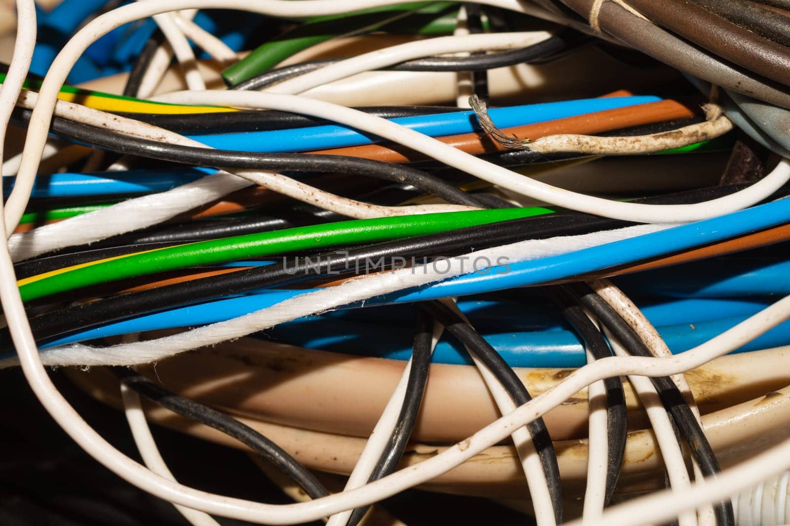 Used electric colorful wires. hank of different old cables close up