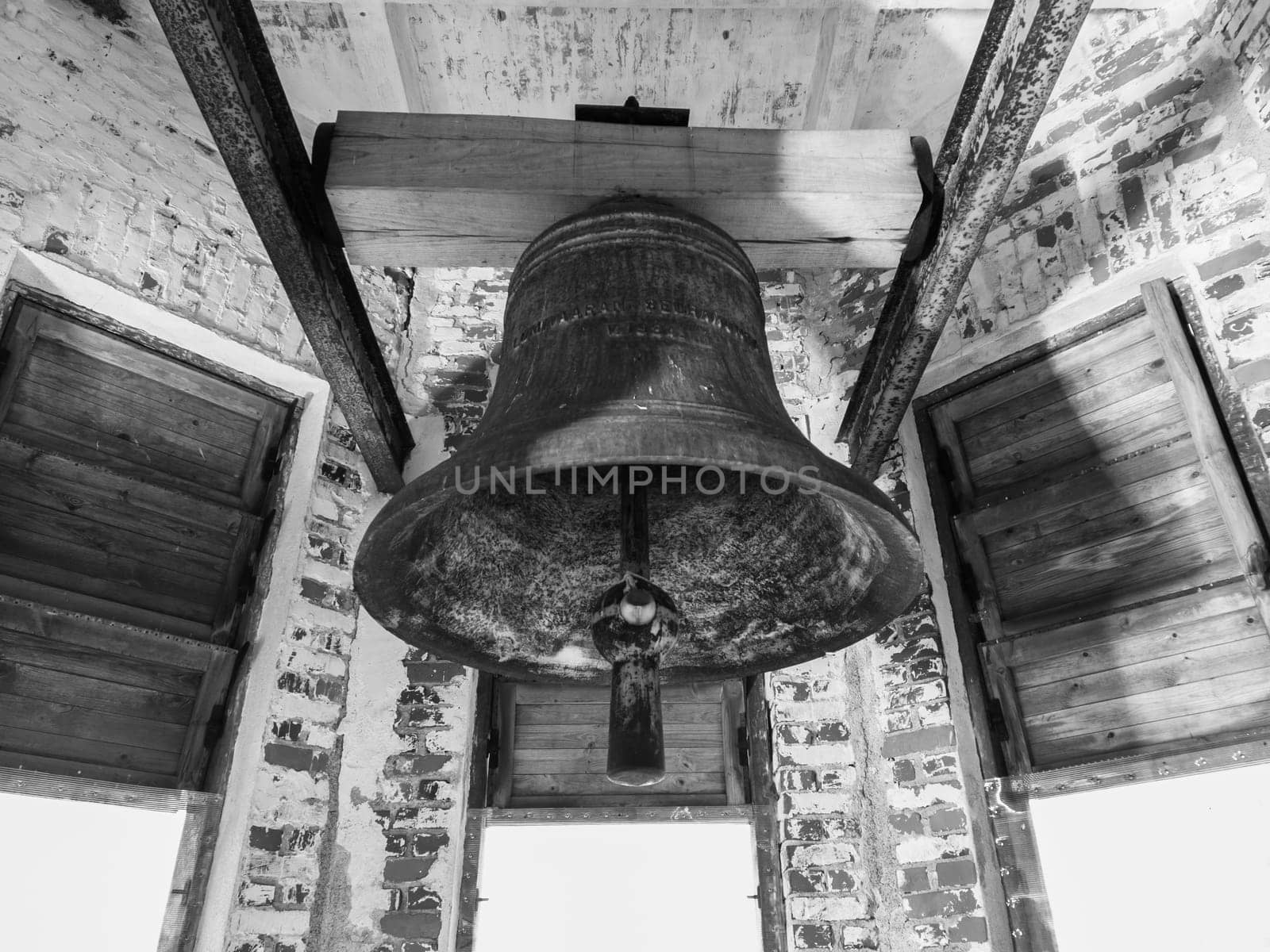 Old church bell. inside the ancient bell tower. abandoned belfry. black and white