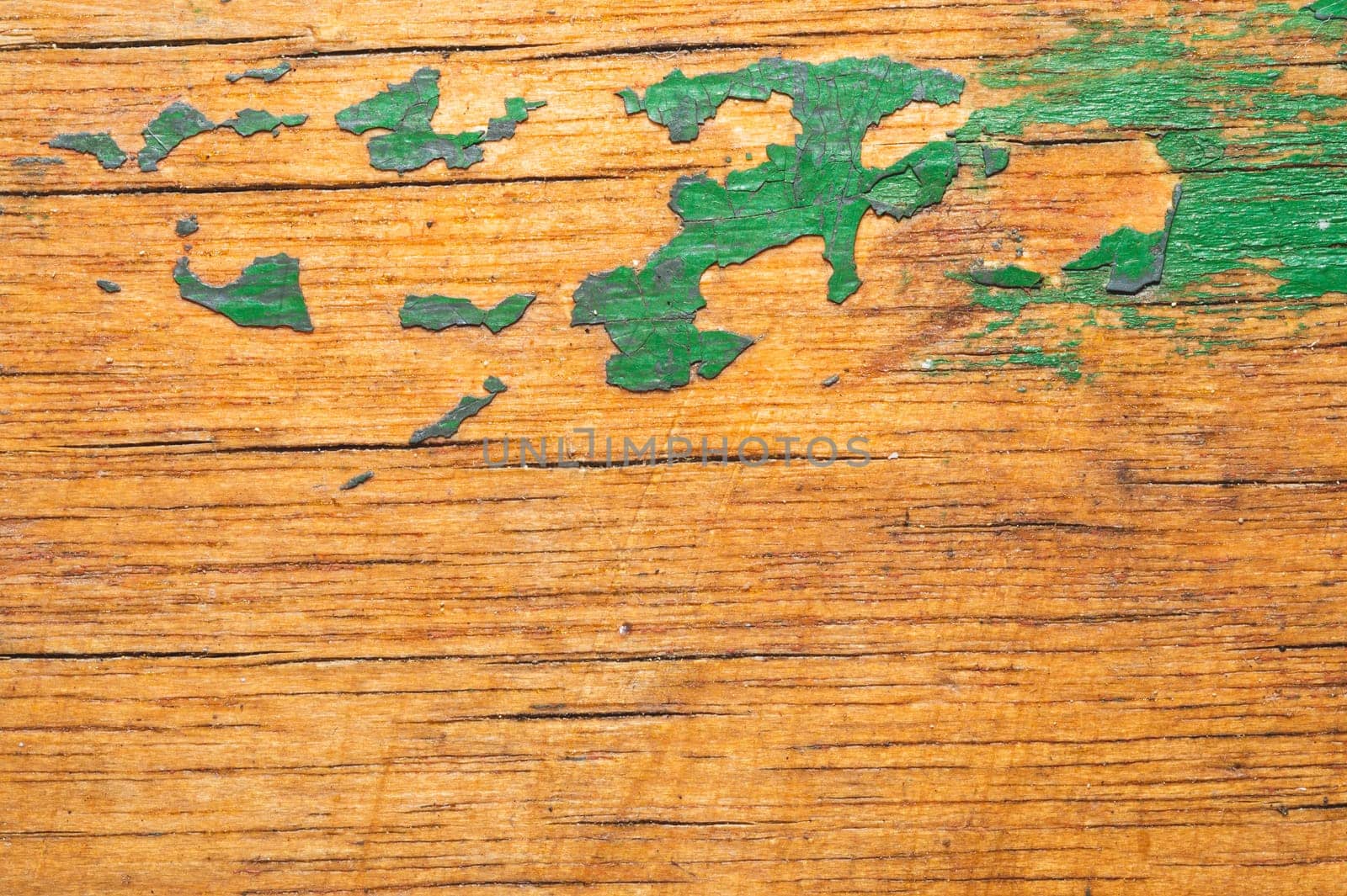 Rough wood with green paint spots. old wooden texture. scratched and cracked surface