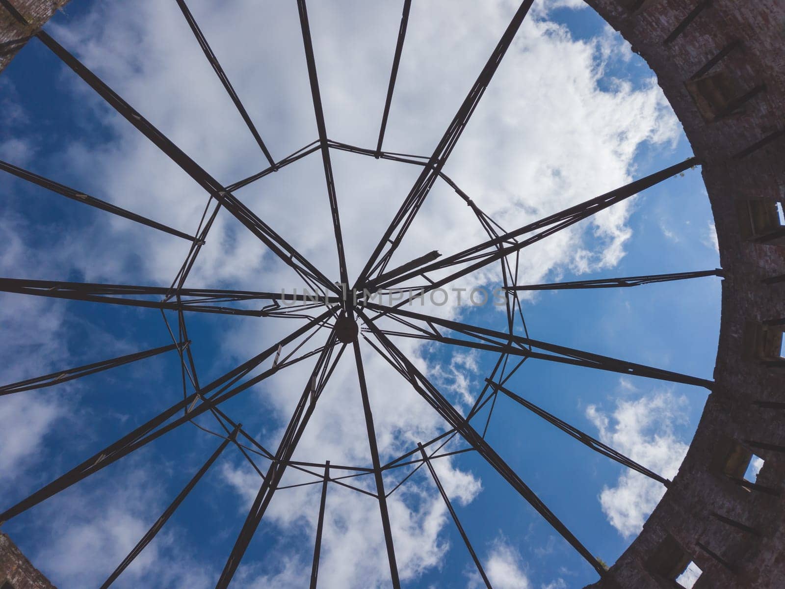 View of the sky through a ruined roof construction. steel carcass for roof mounting