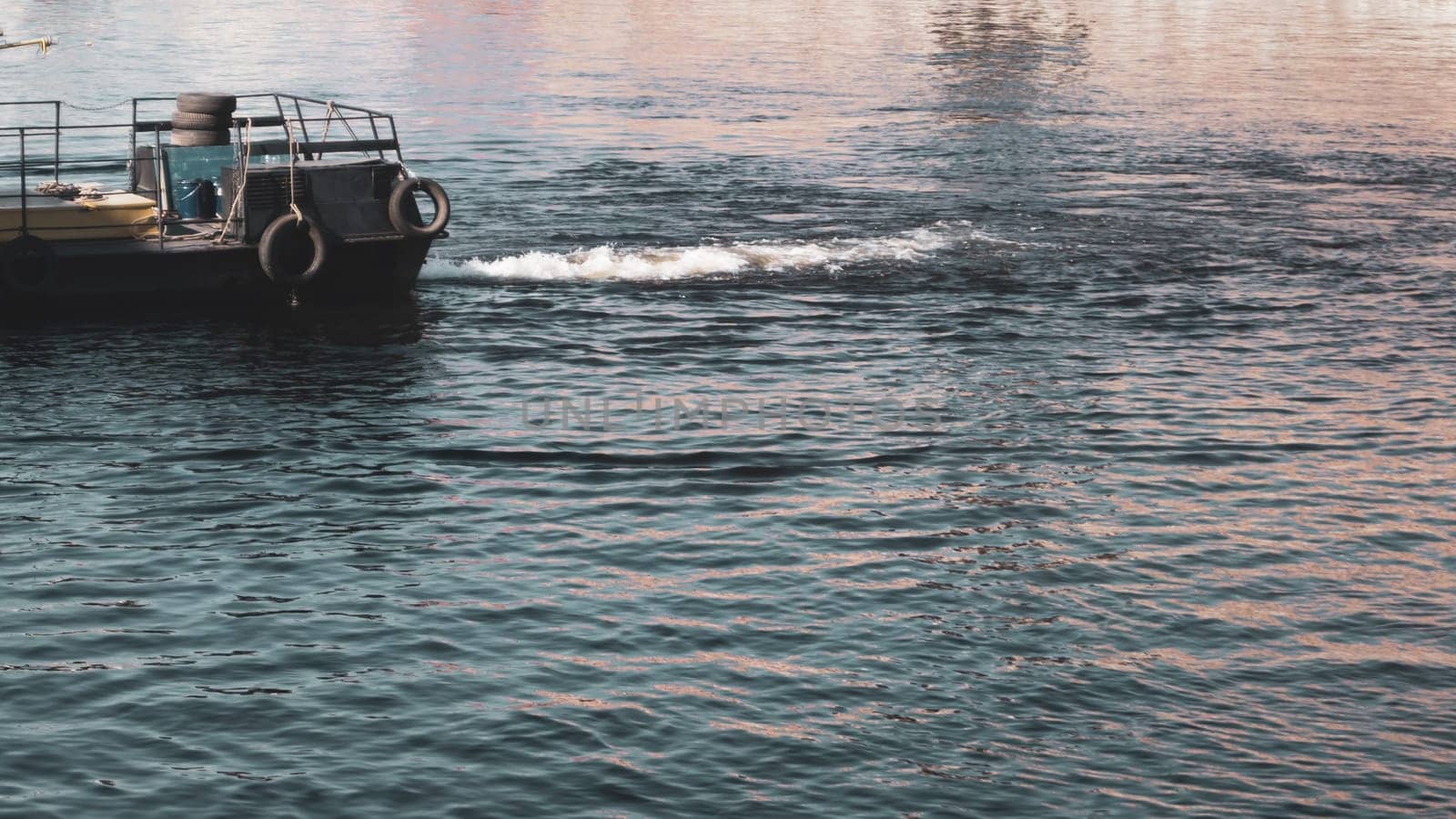 Water surface with ripples and part of a ship. abstract background