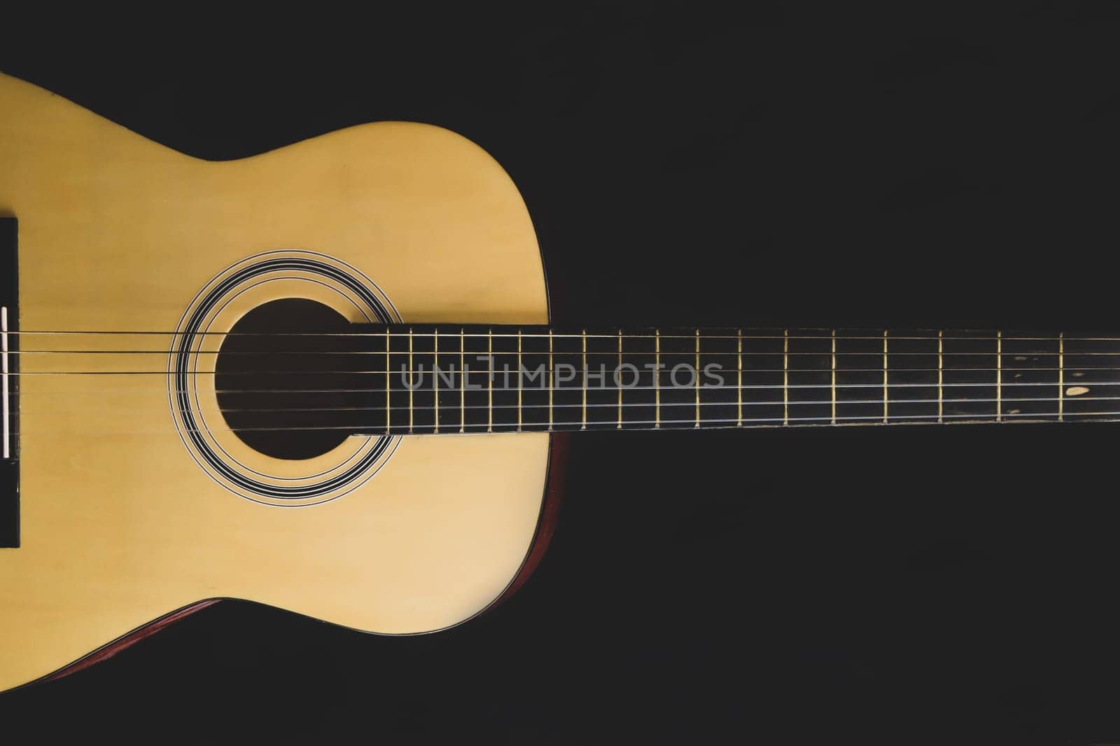 Guitar on the black background. acoustic musical instrument