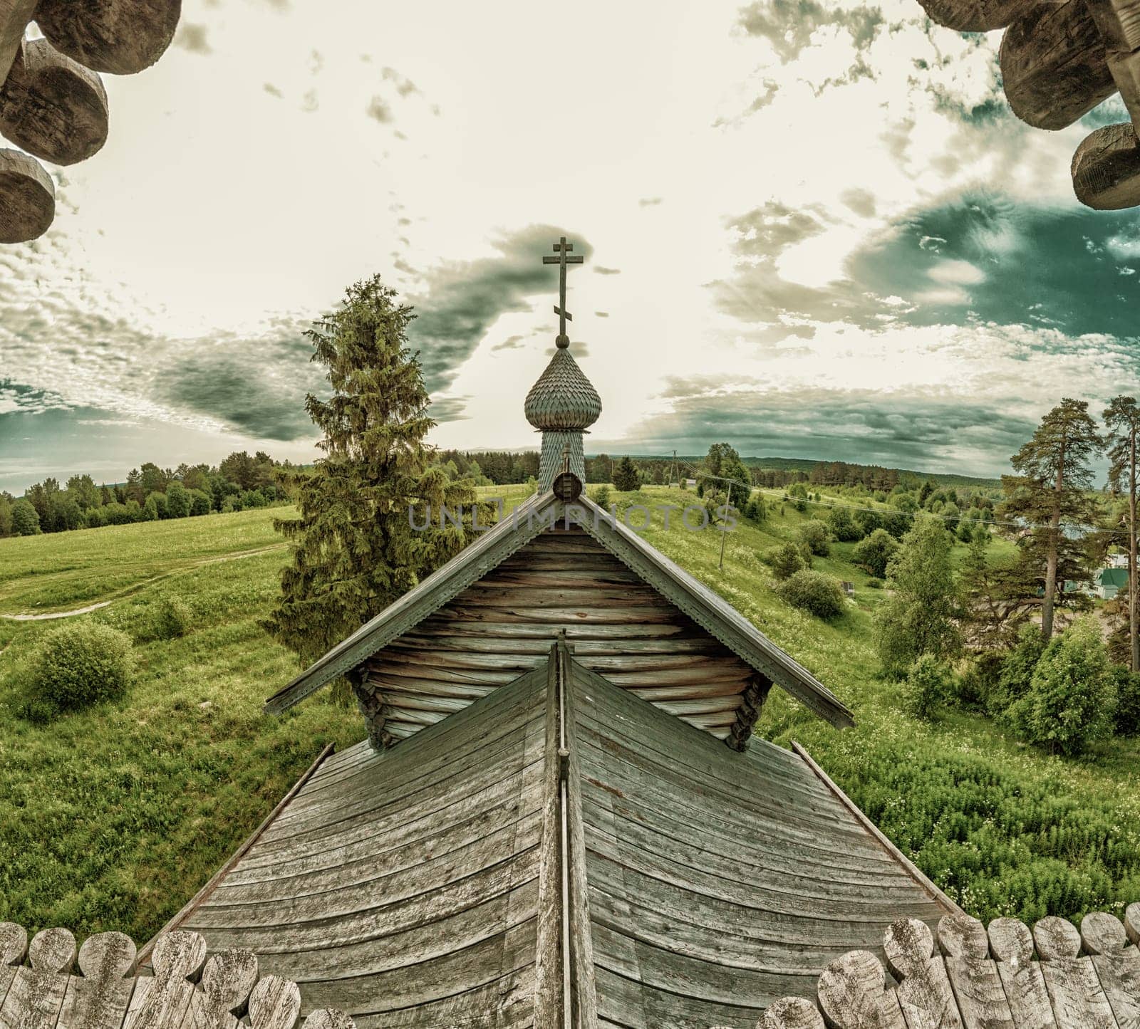 Old wooden church on the pasture field. rural panoramic landscape. roof of ancient chapel. traditional architecture