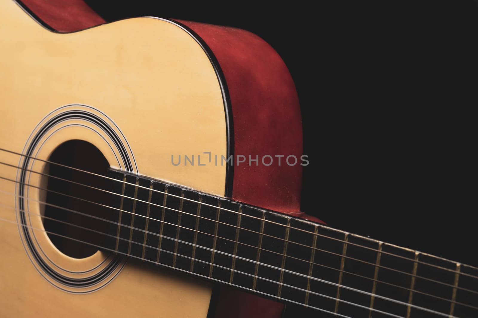 Guitar on the black background. acoustic musical instrument
