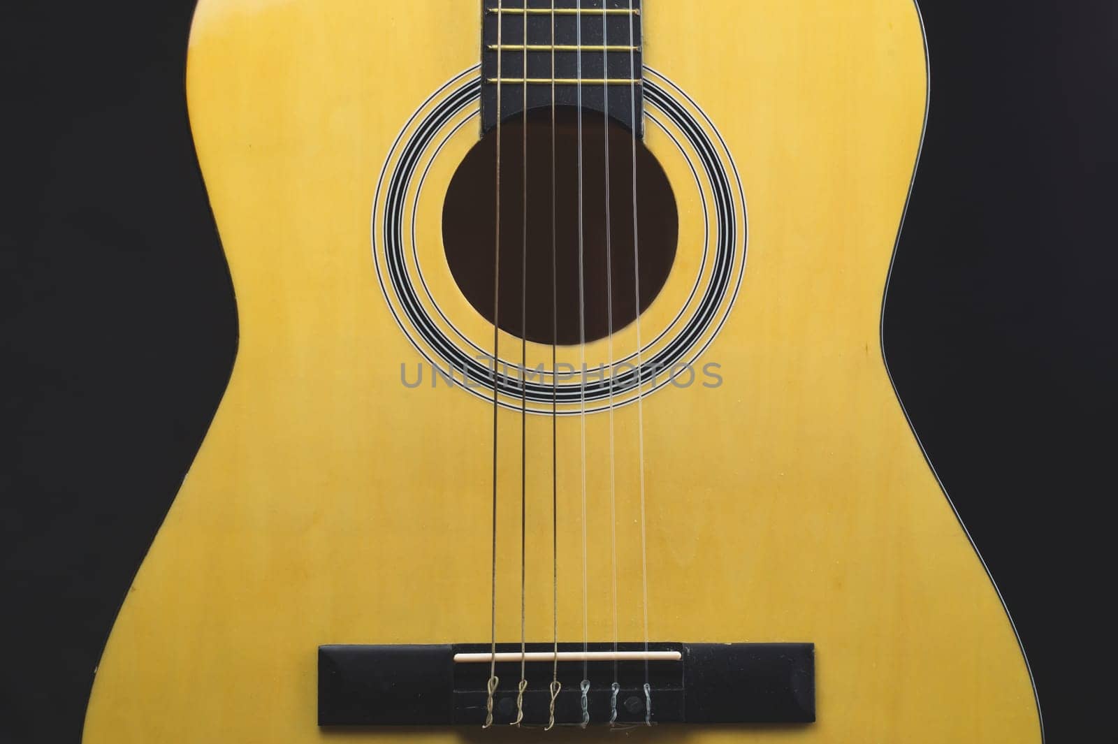 Guitar on the black background. acoustic musical instrument
