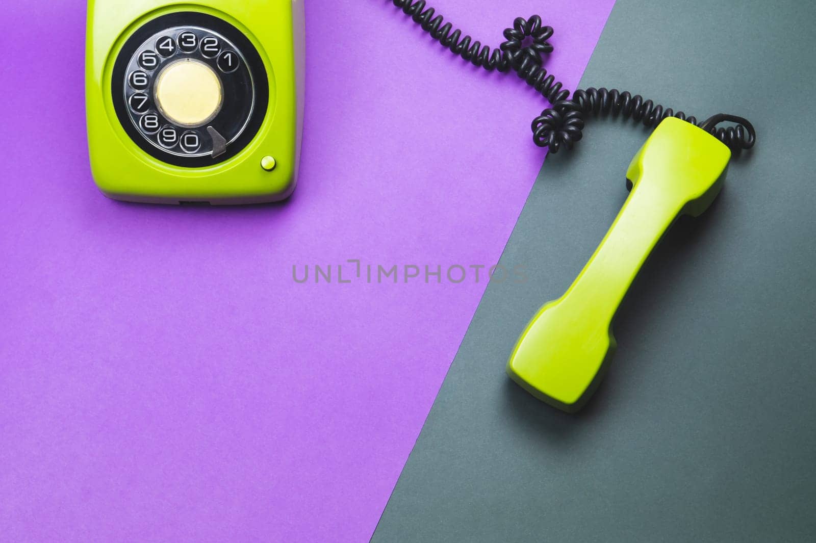 Classic phone with handset. vintage green telephone with phone receiver isolated on color background. old communication technology. copy space