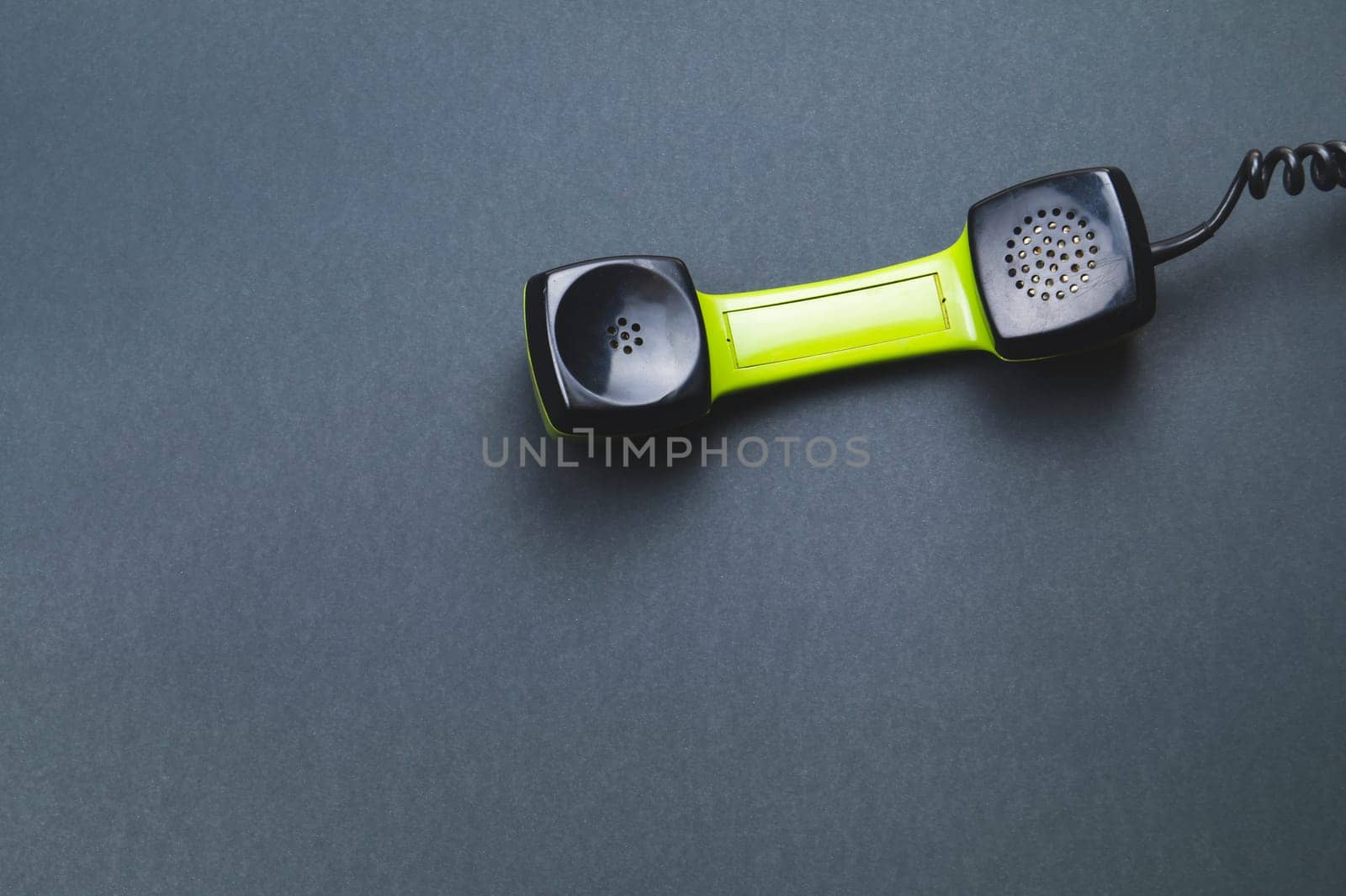Vintage green telephone handset. phone receiver isolated on color background. old communication technology. copy space