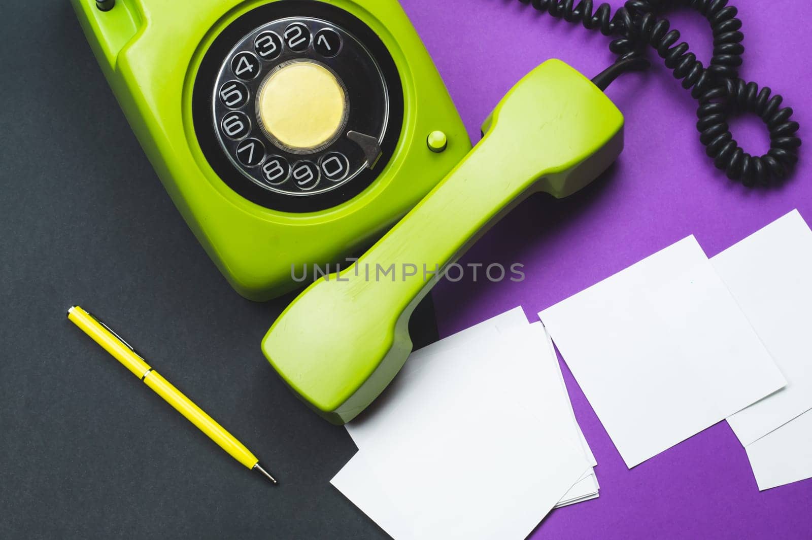 Classic phone with handset. pen with a note. office background. vintage green telephone with phone receiver. old communication technology. copy space