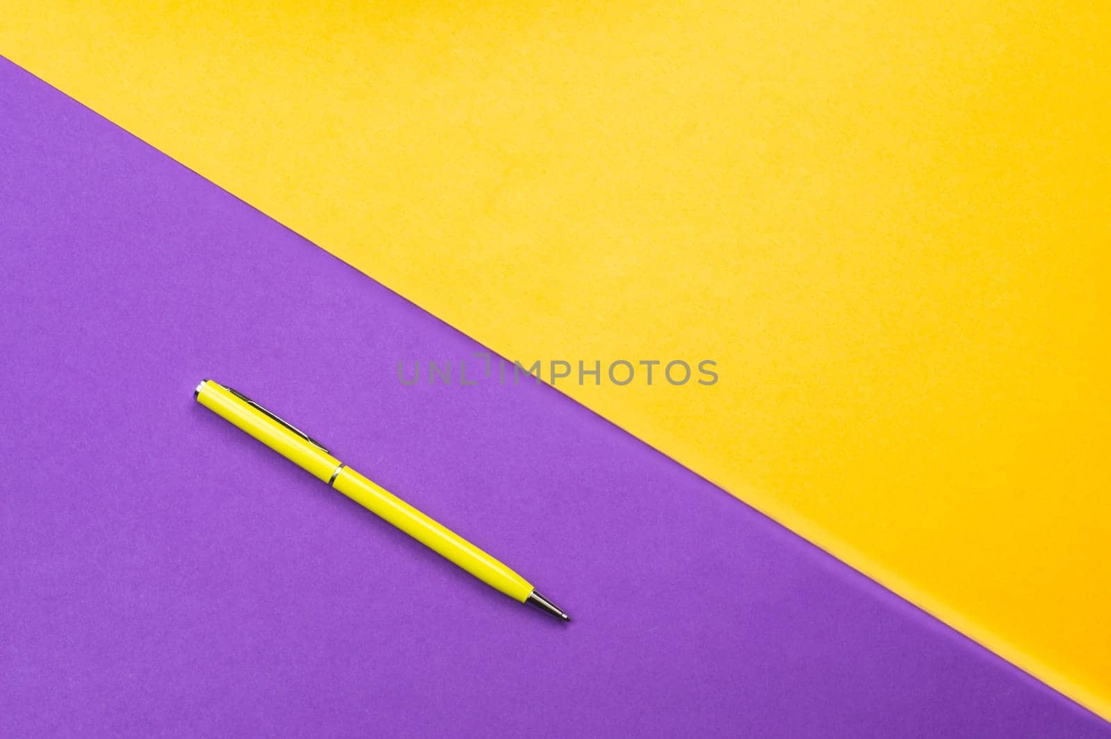 Yellow pen on color background