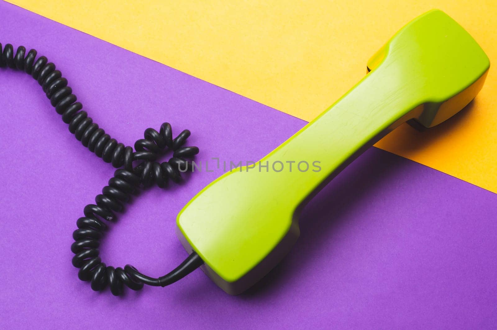 Vintage green telephone handset. phone receiver on color background. old communication technology. copy space
