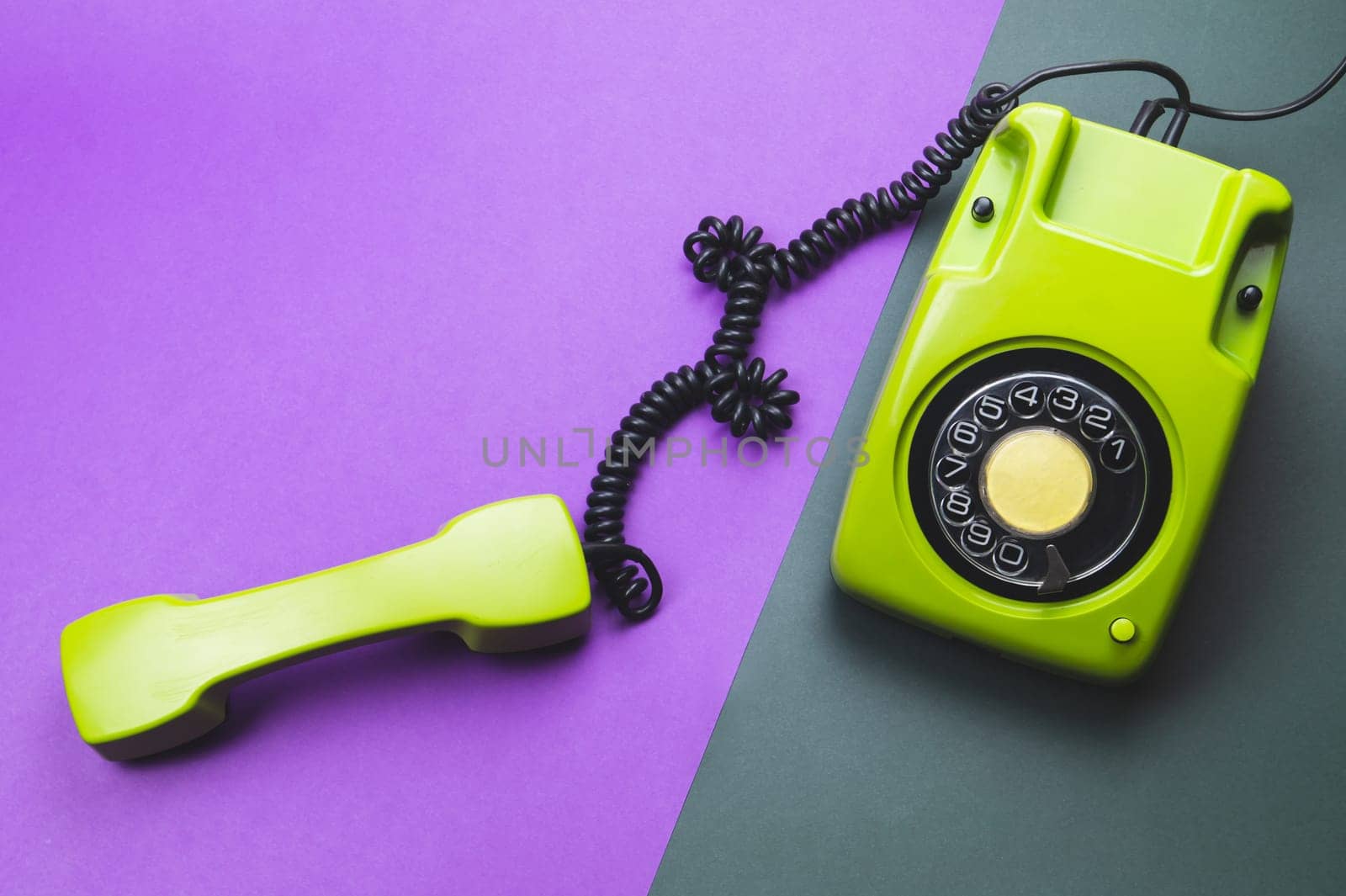Classic phone with handset. vintage green telephone with phone receiver isolated on color background. old communication technology. copy space