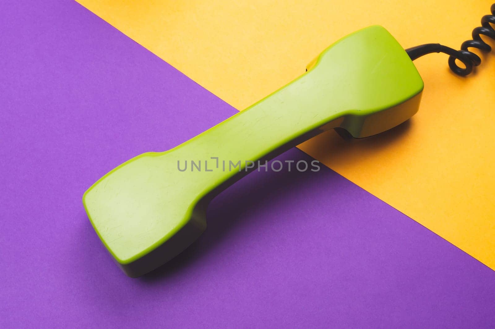 Vintage green telephone handset. phone receiver on color background. old communication technology. copy space
