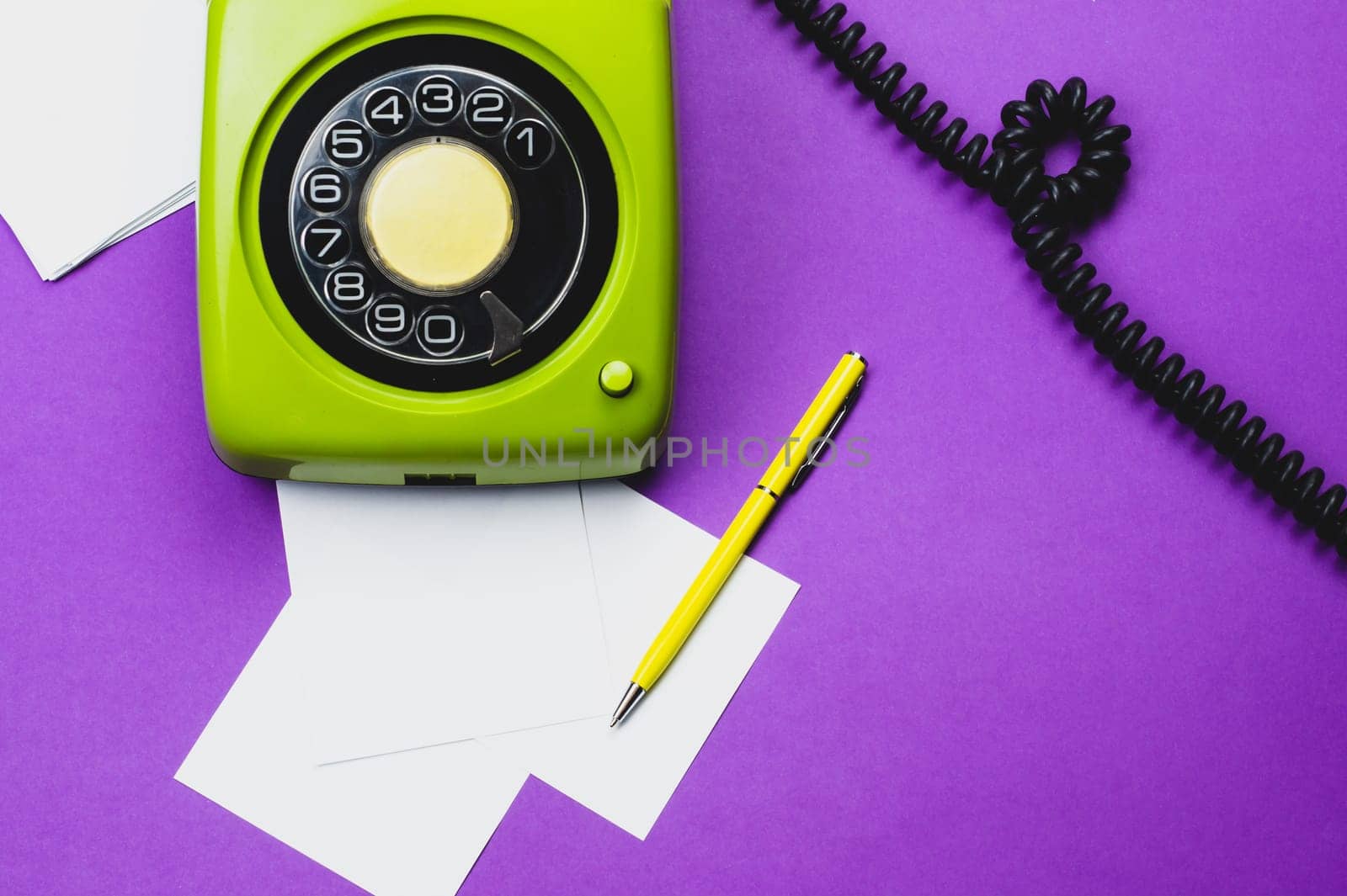 Classic phone with handset. pen with a note. office background. vintage green telephone with phone receiver. old communication technology. copy space