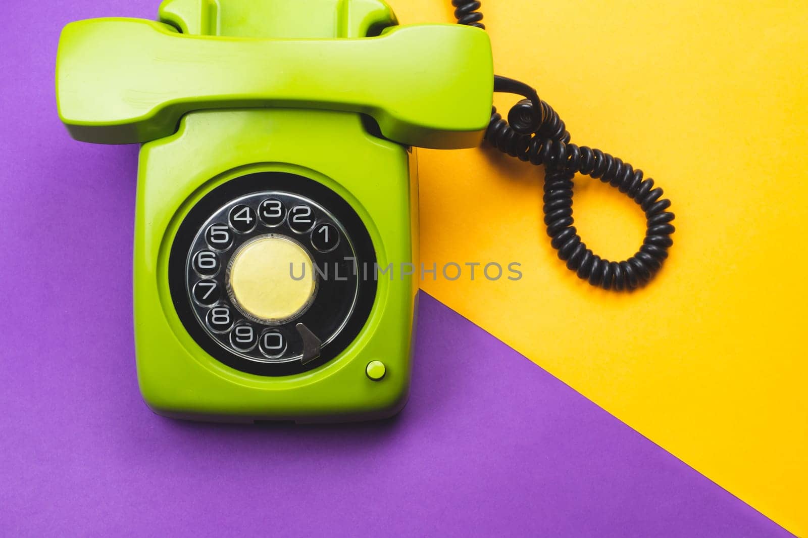 Classic phone with handset. vintage green telephone with phone receiver on color background. old communication technology. copy space