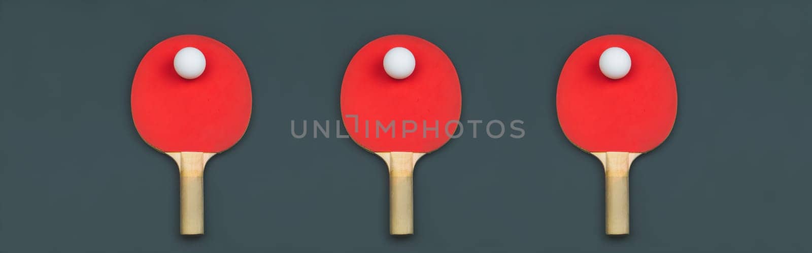 Red table tennis rackets with balls on a colored background. sport equipment for ping pong