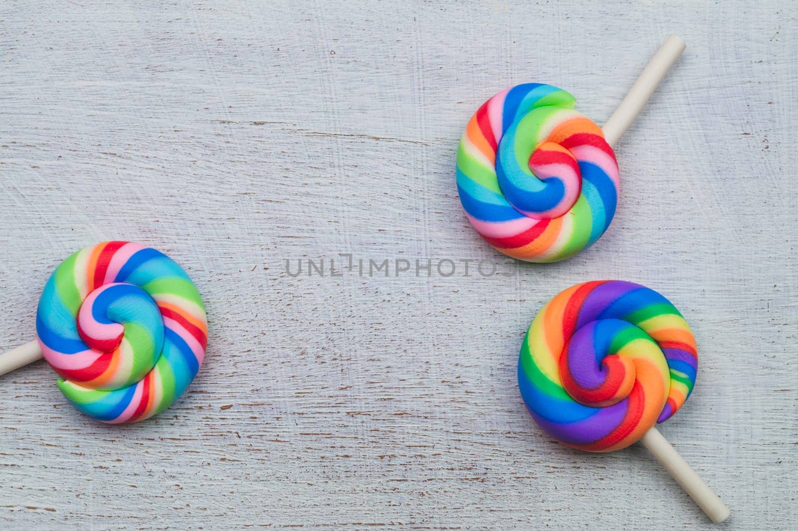 Lollipops on white wooden background. colorful candies close up. copy space