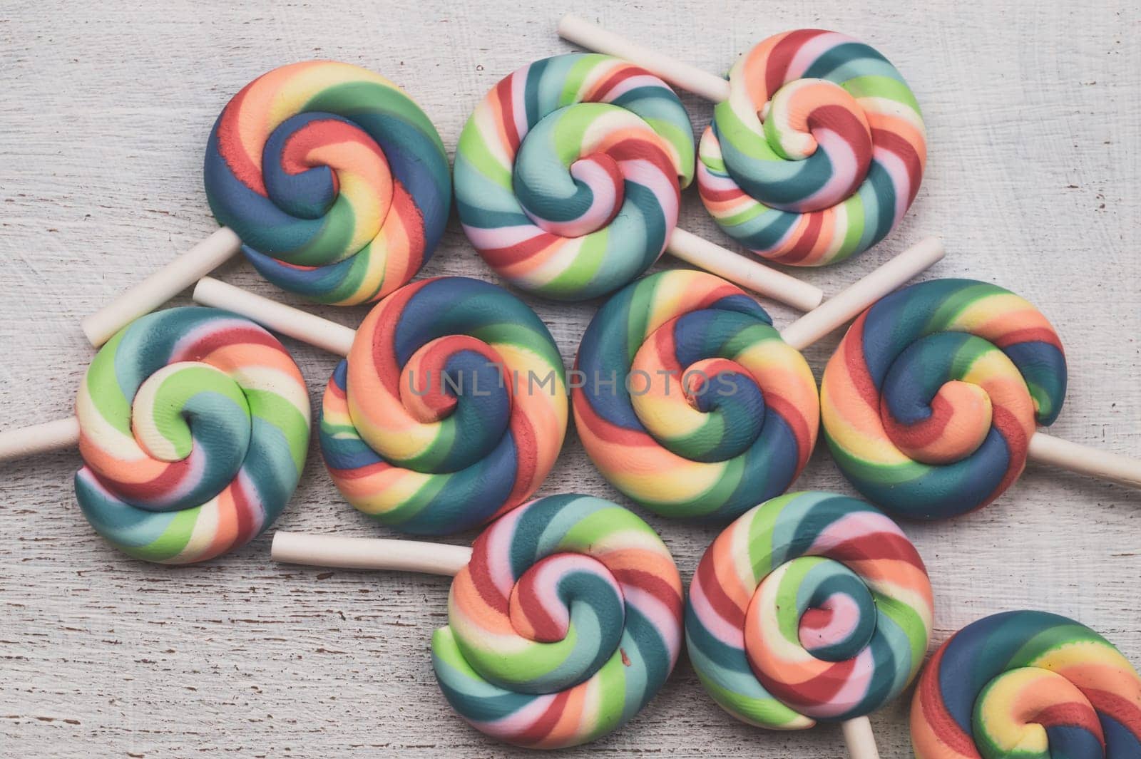 Lollipops on white wooden background. colorful candies close up