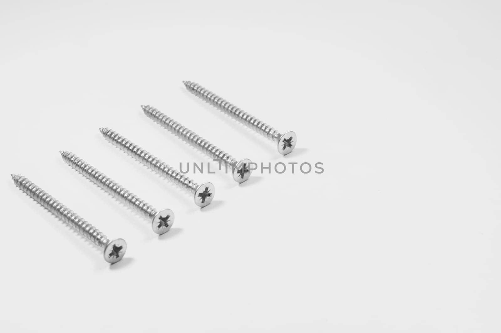 Steel screw on a white background. working tools