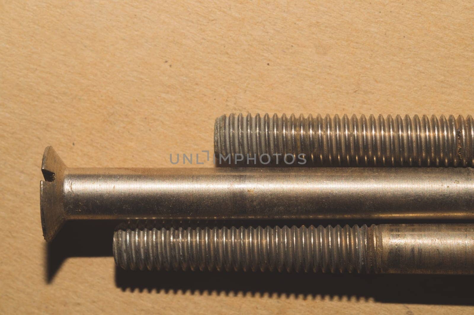 Screws on a cardboard background. work tool