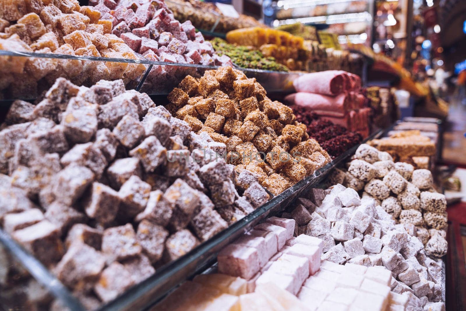 rows of Turkish delight sweets desserts with dried fruits lined up in the store window