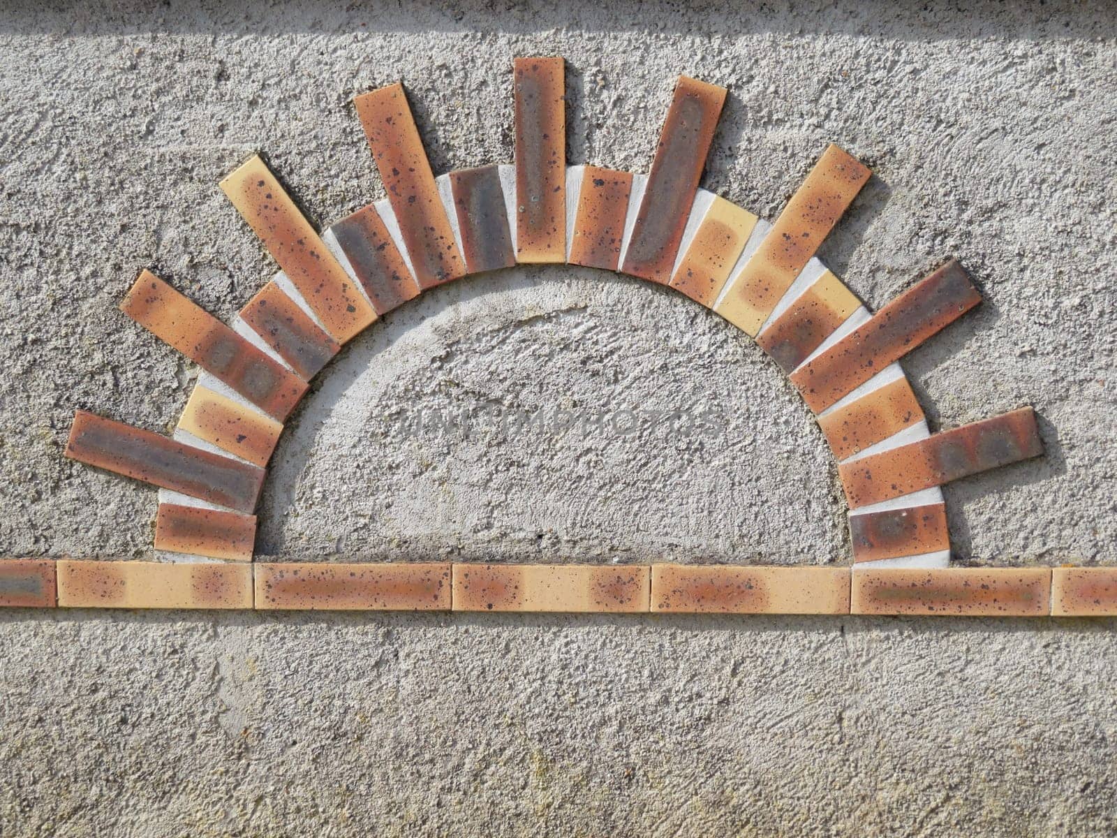 beautiful figure made with sun-shaped bricks colors building materials