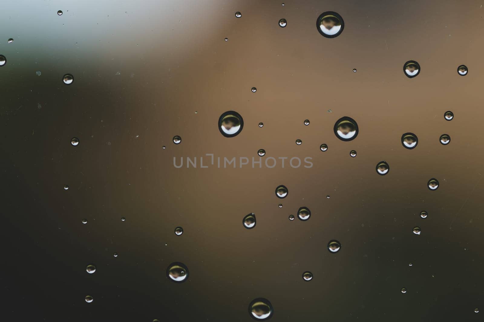 Raindrops on window glass close up. water drops macro background