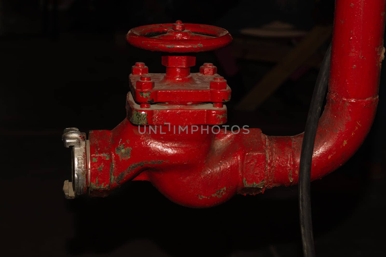 Red valve installed at fire hydrant pipe. old industrial faucet